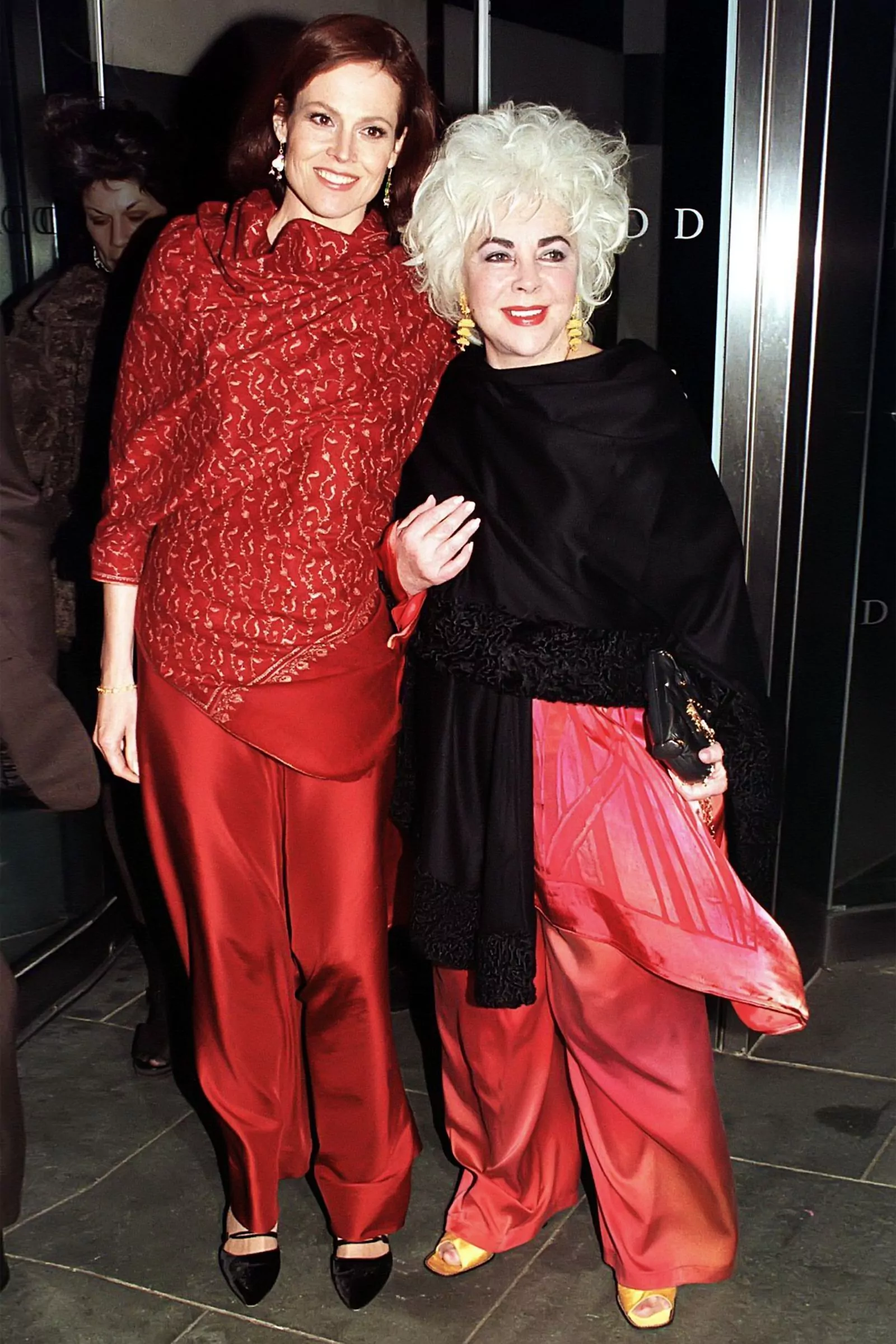 Elizabeth Taylor and Sigourney Weaver at Christie's auction in aid of amfAR, March 15, 1999.
