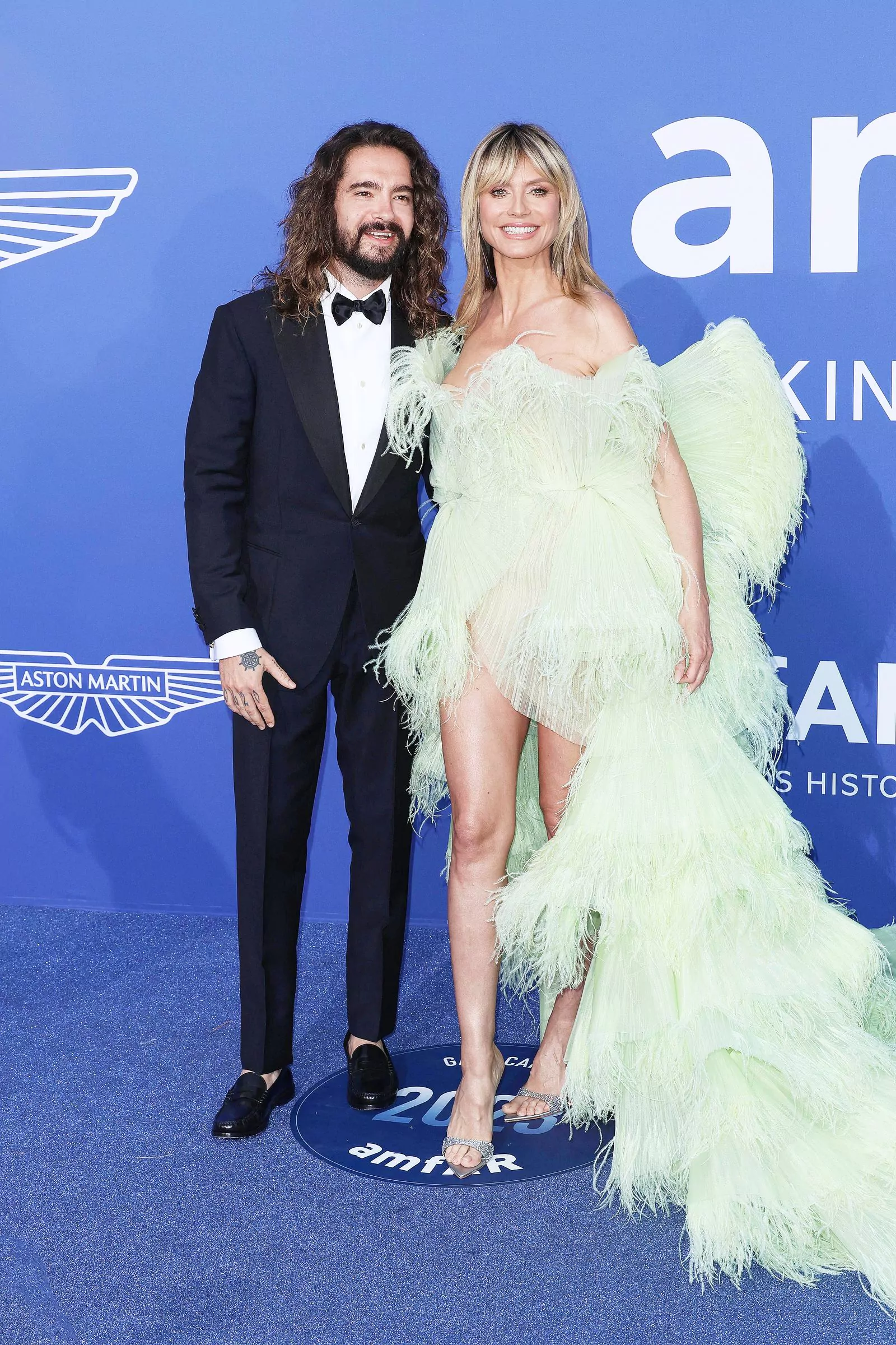 Heidi Klum in Georges Hobeika's Spring 2023 Couture with husband Tom Kaulitz at the amfAR Gala Dinner, May 25, 2023. Heidi Klum in Georges Hobeika's Spring 2023 Couture with husband Tom Kaulitz at the amfAR Gala Dinner in Cannes on May 25, 2023.