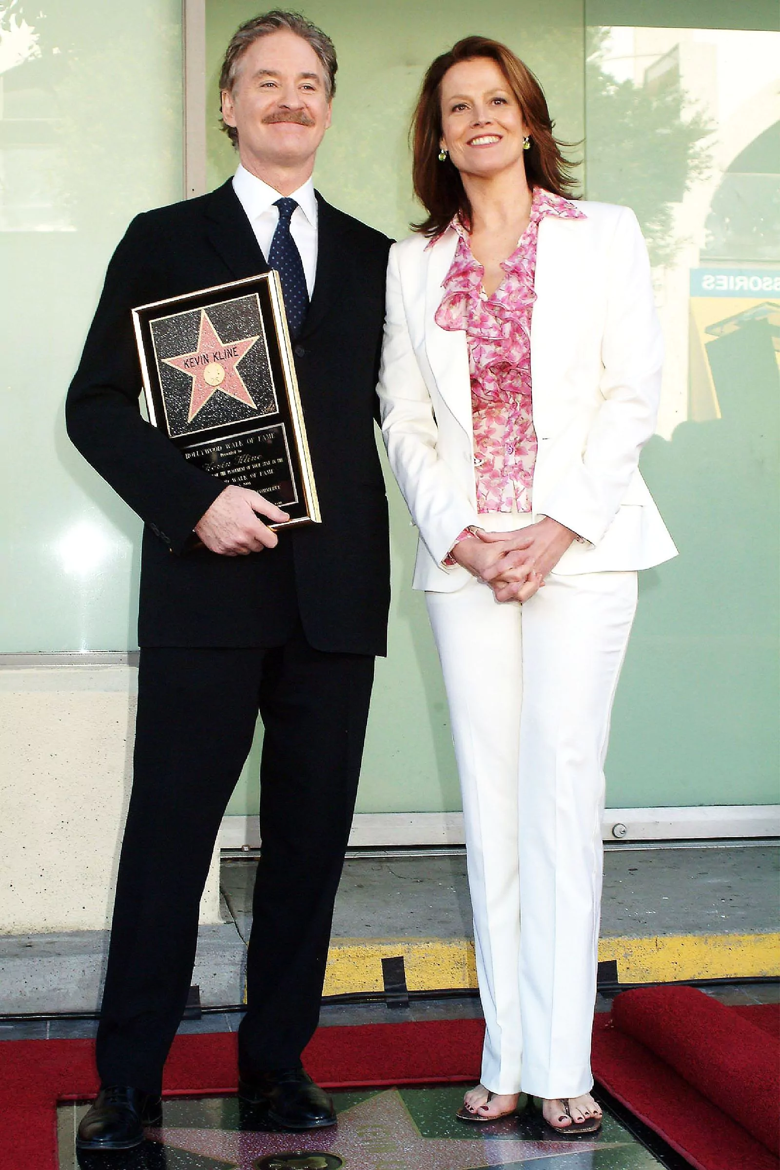 Kevin Kline and Sigourney Weaver at the ceremony to honor actors with a star on the Hollywood Walk of Fame, December 3, 2004.